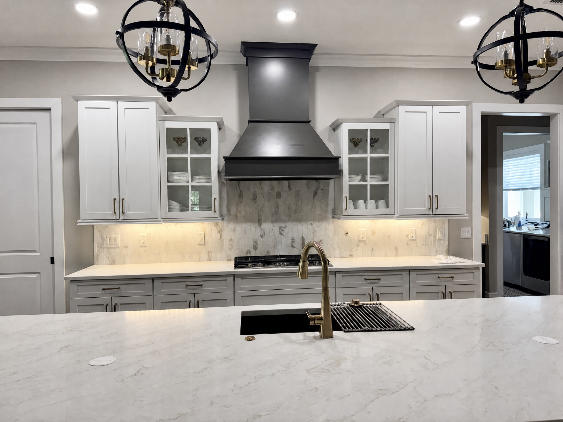 Tampa Bay cabinet refinishing project — Refinished kitchen with dark custom range hood