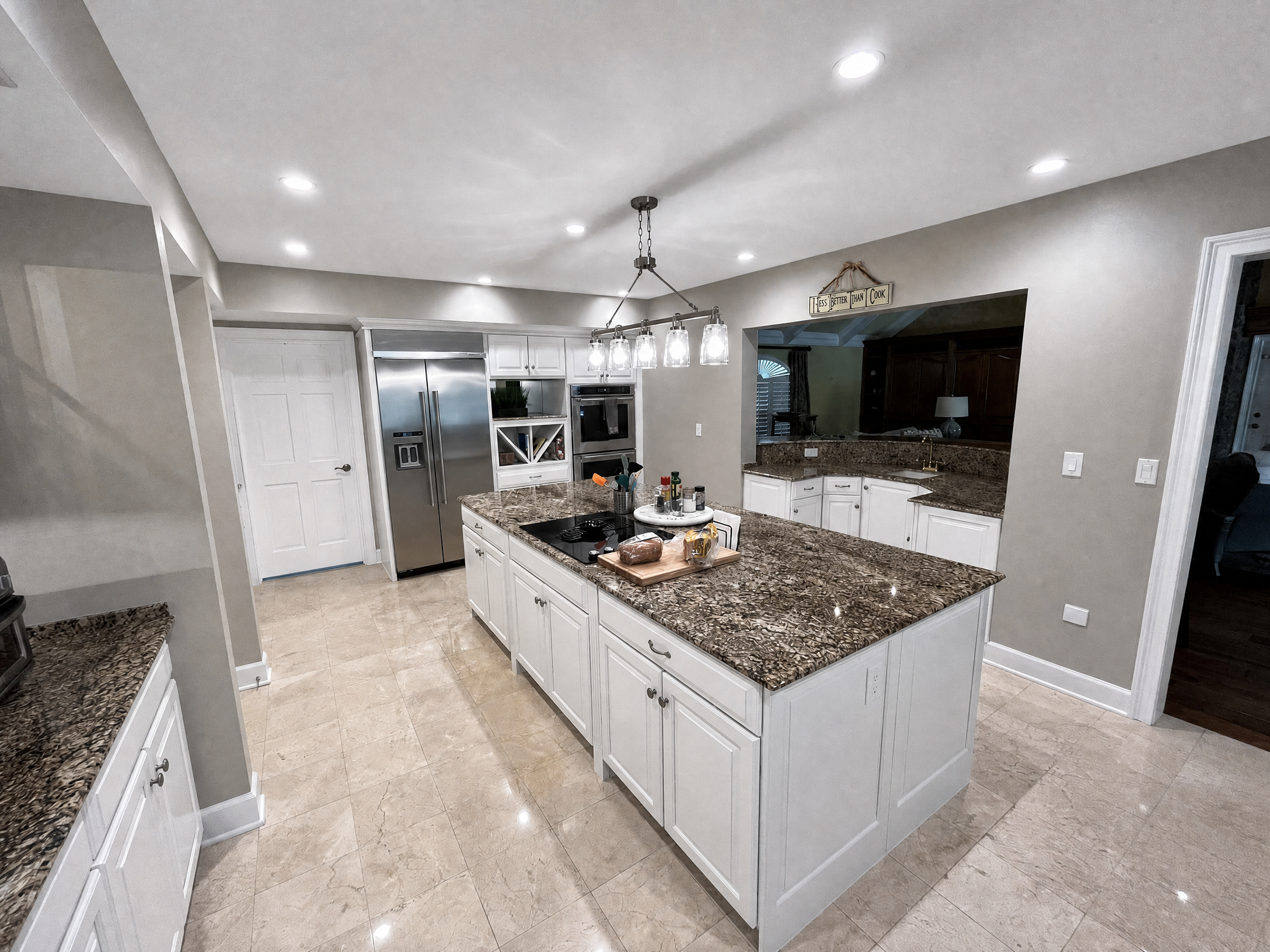 Tampa Bay cabinet refinishing project — Pure white refinished kitchen with granite island