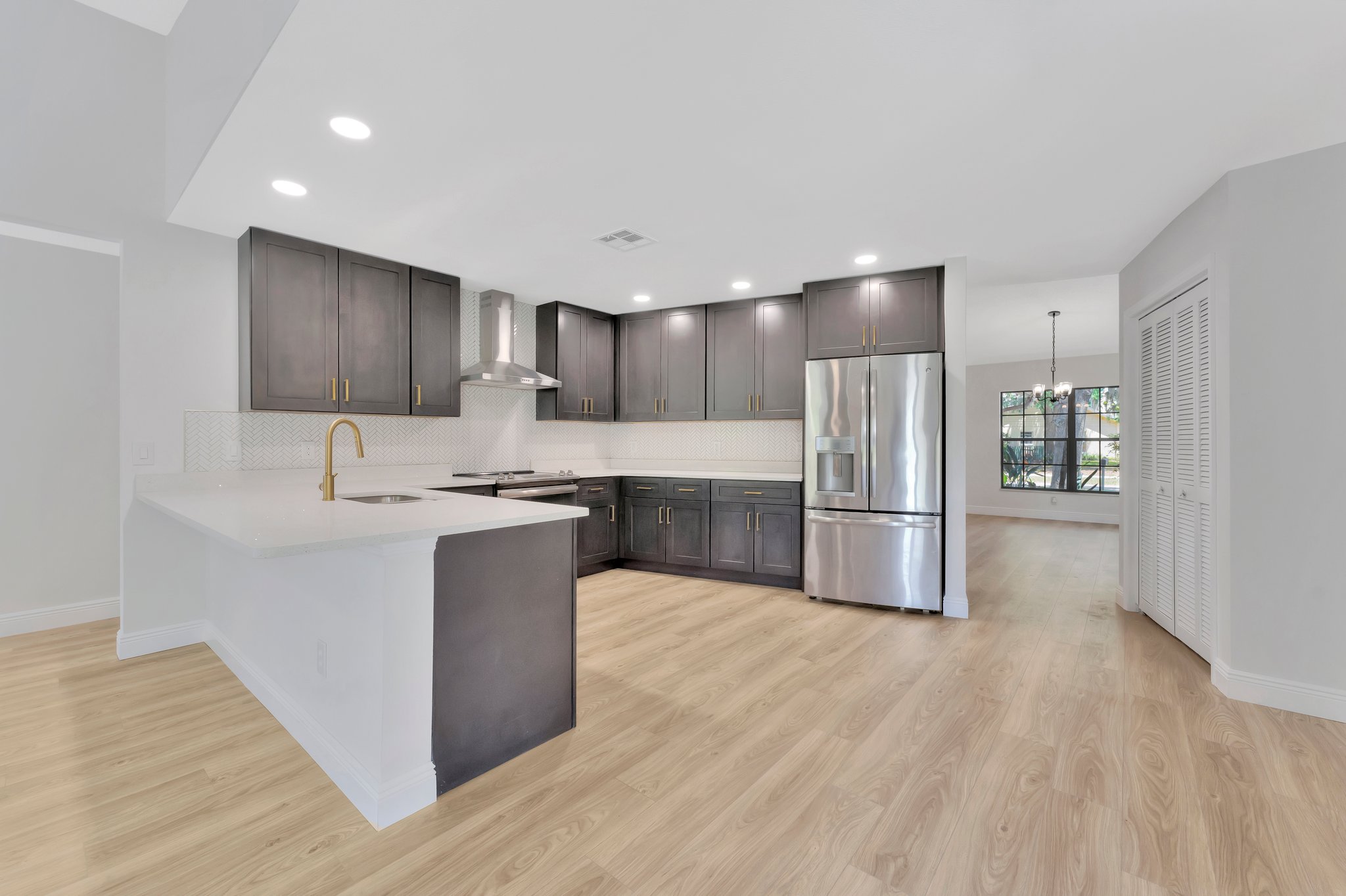 Tampa Bay kitchen remodeling — grey shaker kitchen remodel with brass hardware