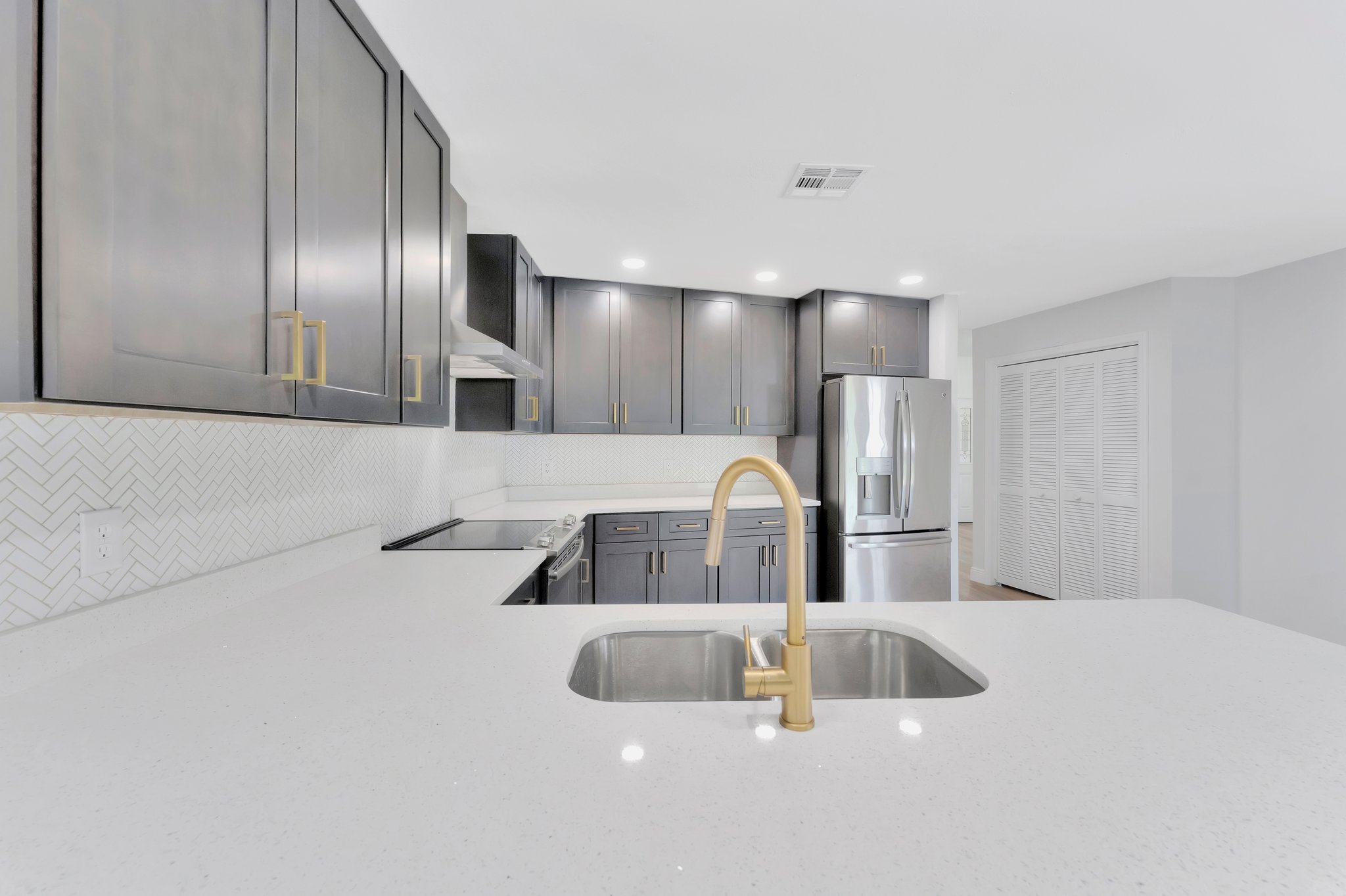 Tampa Bay kitchen remodeling — grey shaker kitchen remodel with brass hardware