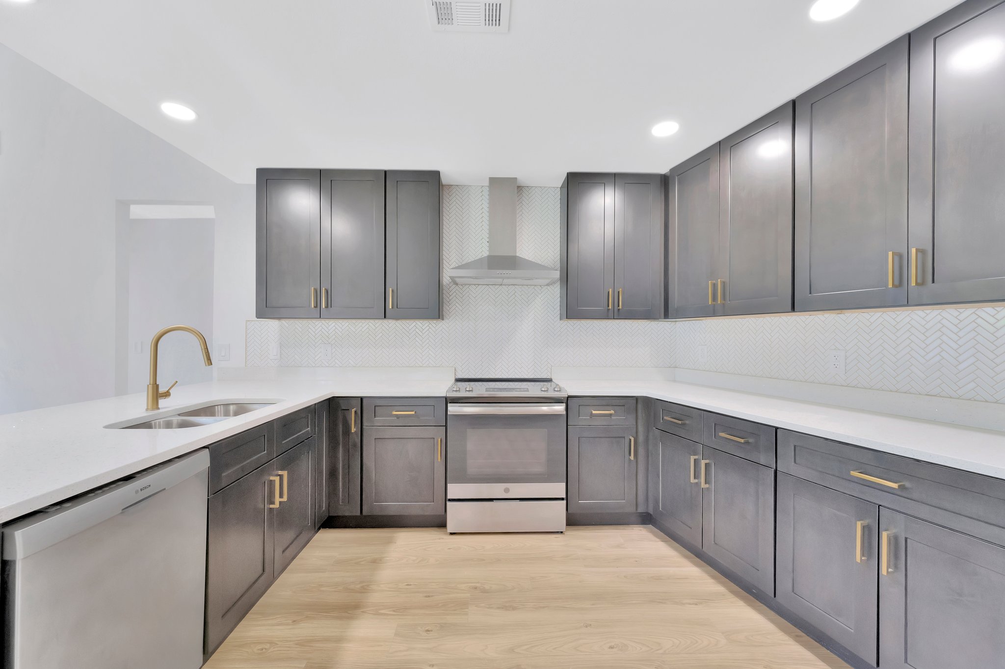 Tampa Bay kitchen remodeling — grey shaker kitchen remodel with brass hardware