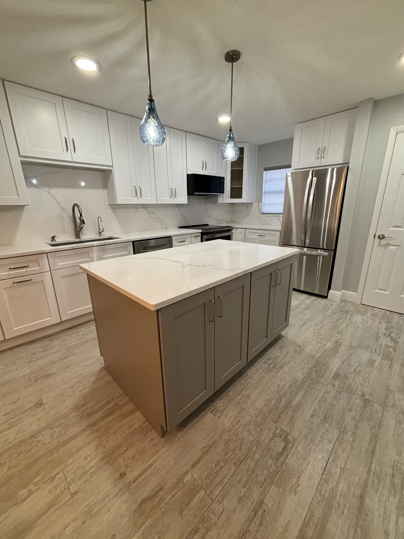 Tampa Bay kitchen remodeling — grey shaker kitchen remodel with brass hardware