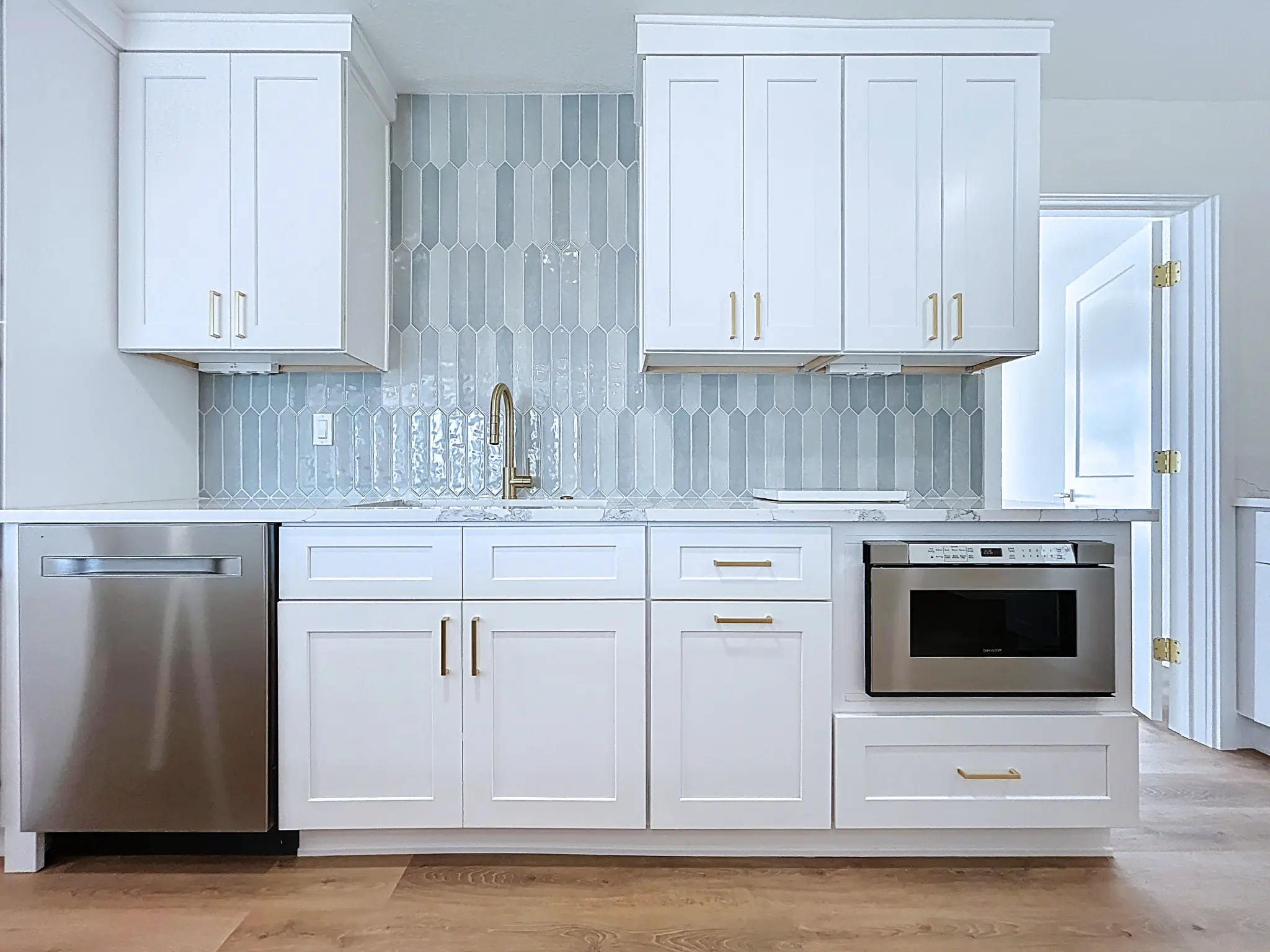 Tampa Bay kitchen remodeling — white and natural shaker kitchen with brass details