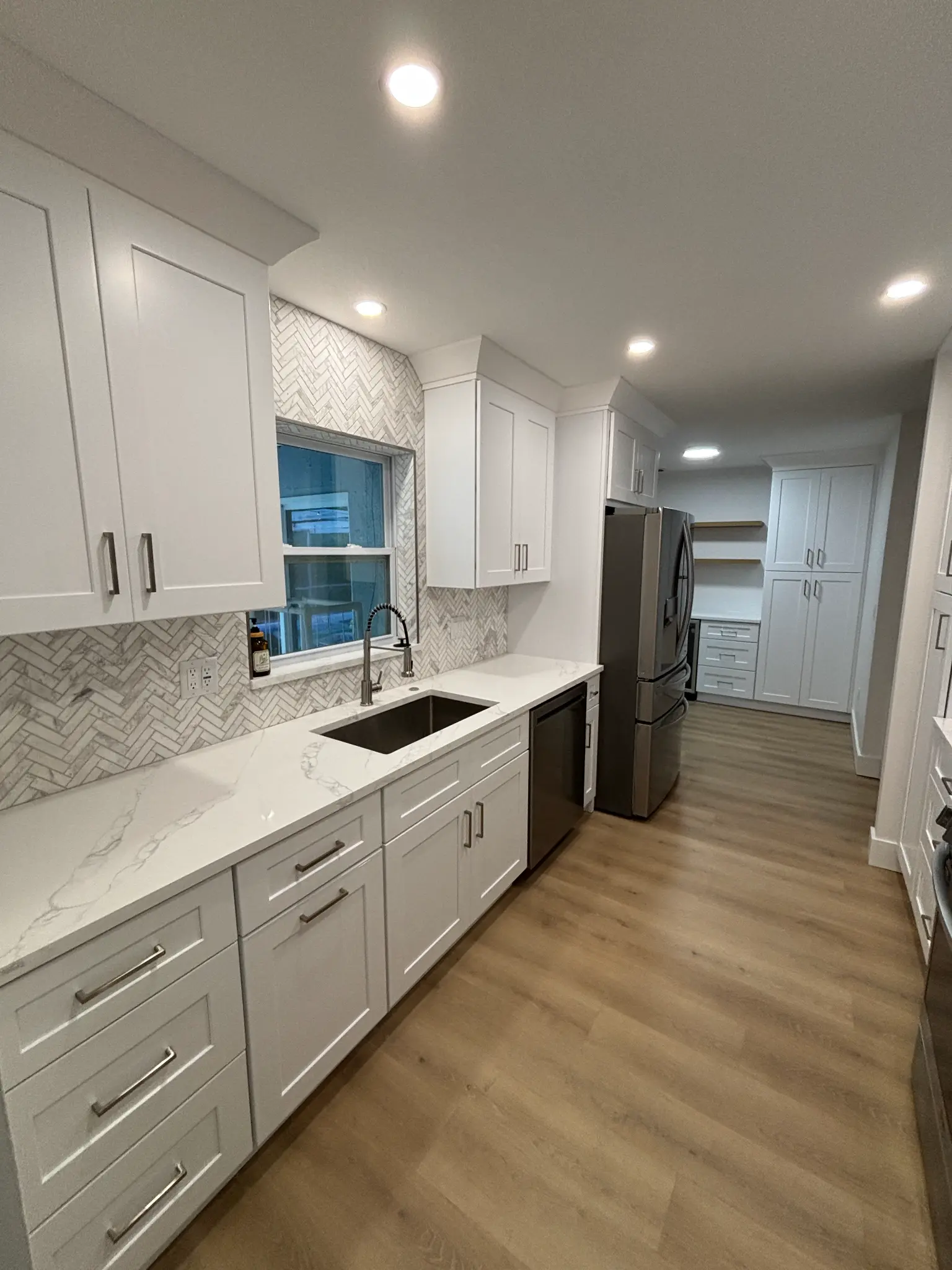 Tampa Bay kitchen remodeling — white shaker kitchen with chevron tile backsplash