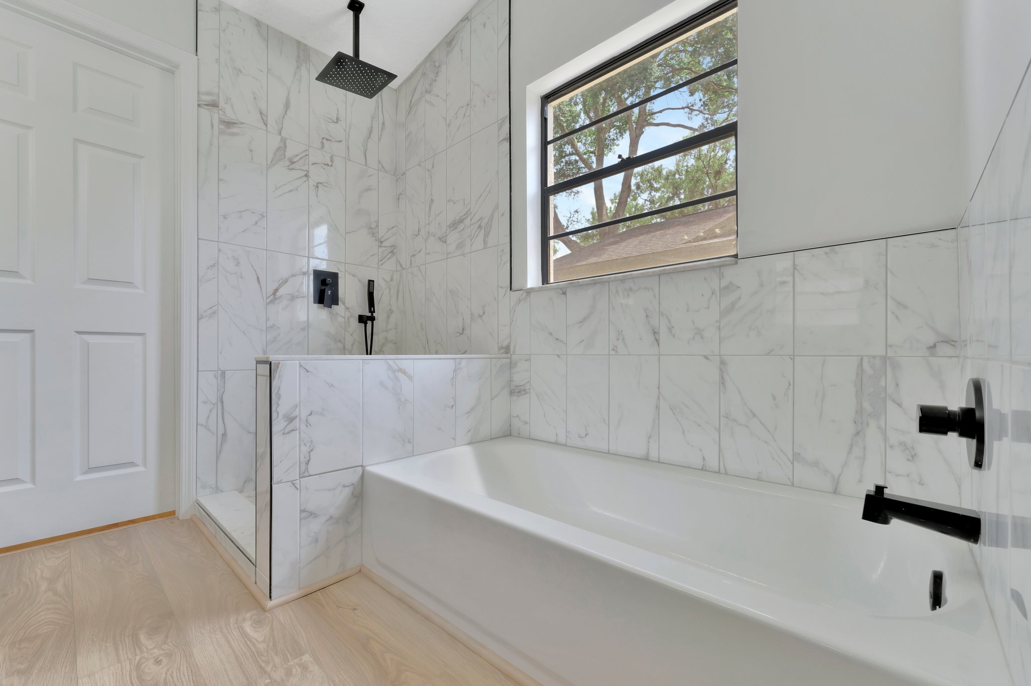 Tampa Bay bathroom remodeling — white bathroom renovation with black fixtures