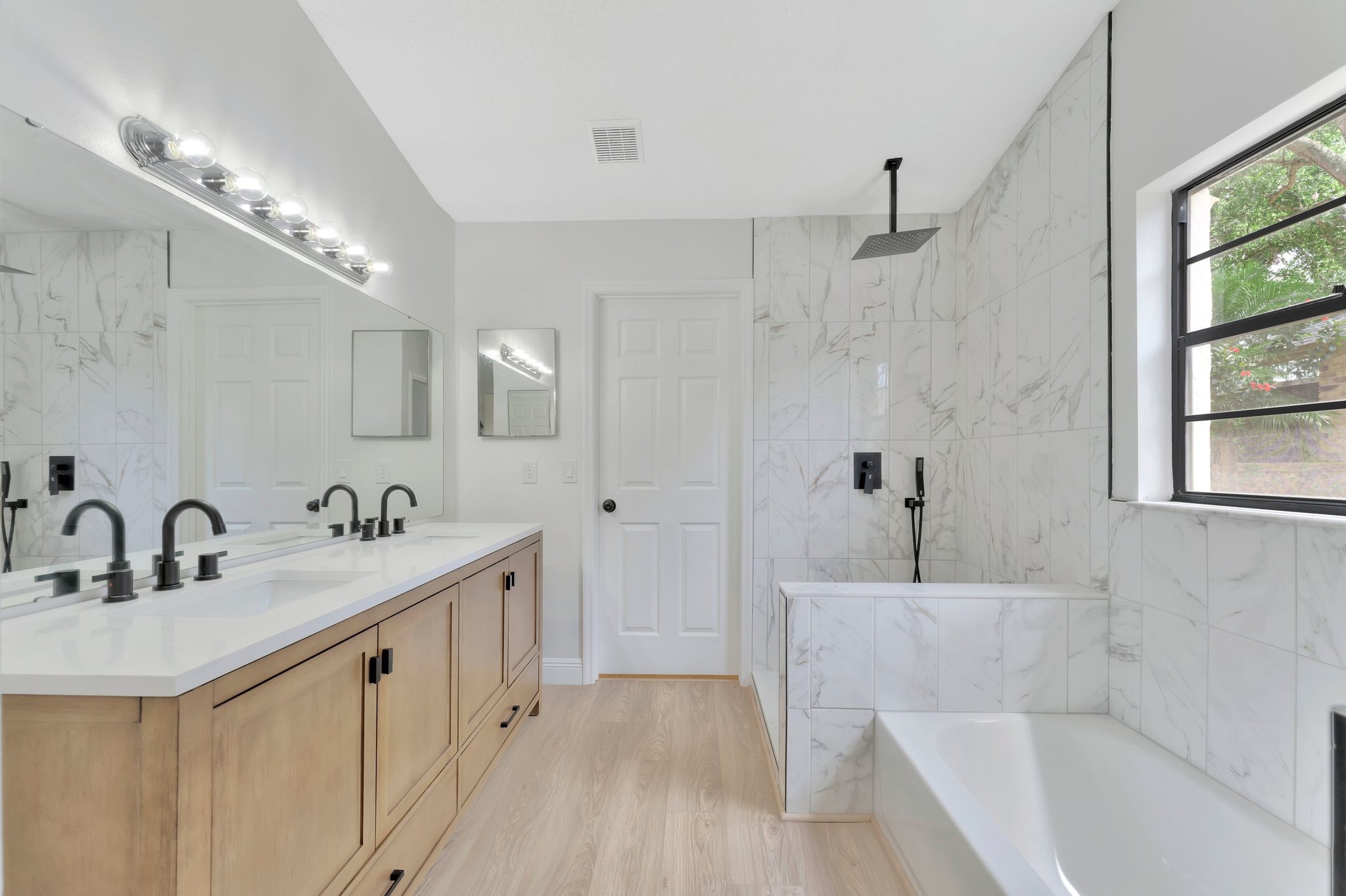 Tampa Bay bathroom remodeling — white bathroom renovation with black fixtures