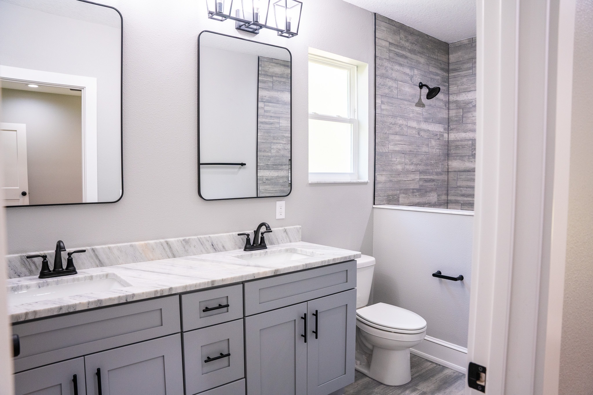 Tampa Bay bathroom remodeling — white bathroom renovation with black fixtures
