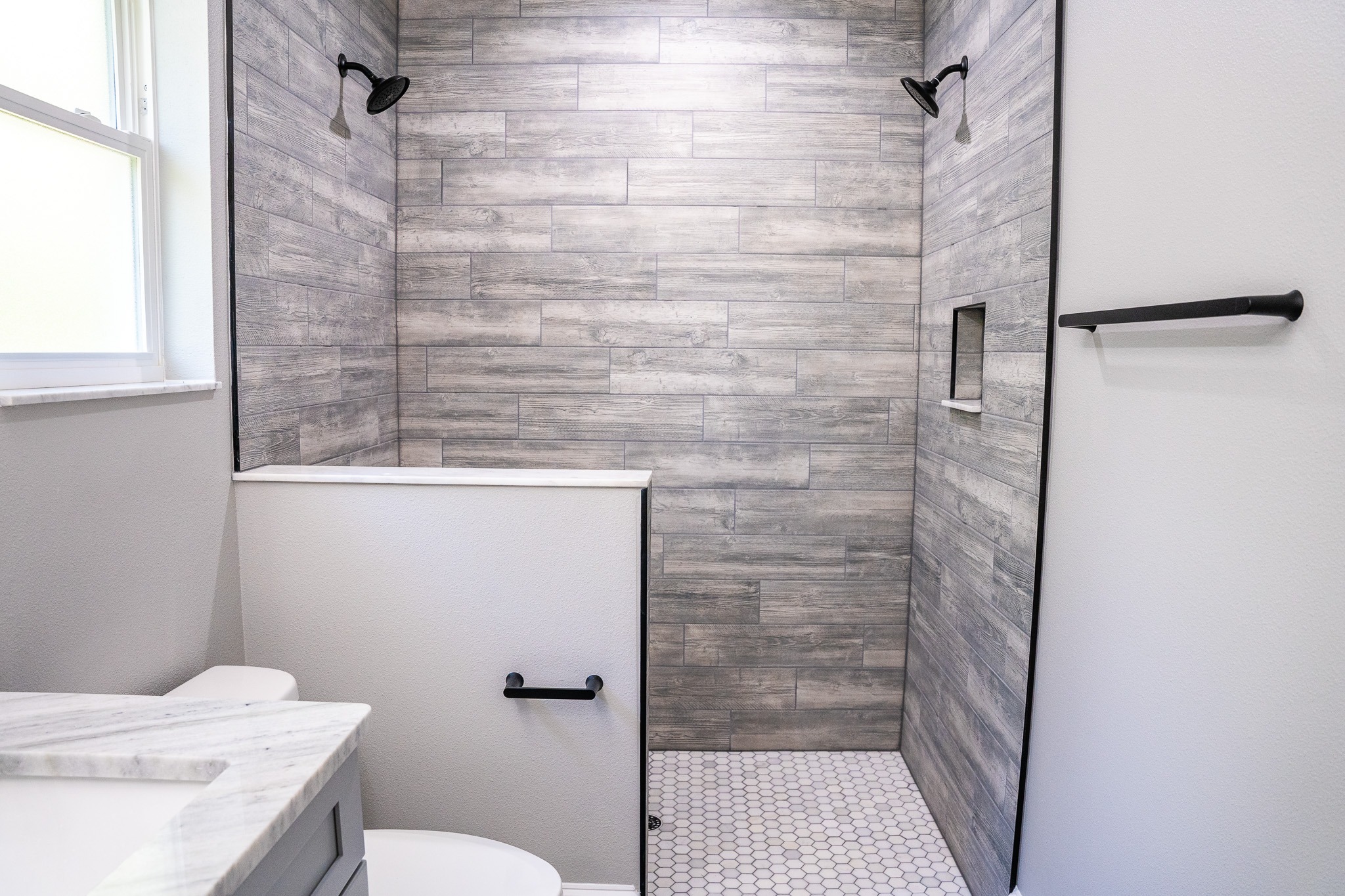 Tampa Bay bathroom remodeling — grey tiled walk-in shower bathroom renovation