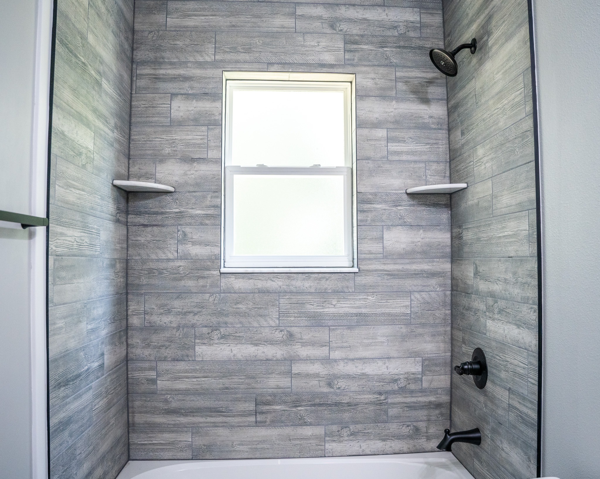 Tampa Bay bathroom remodeling — grey tiled walk-in shower bathroom renovation