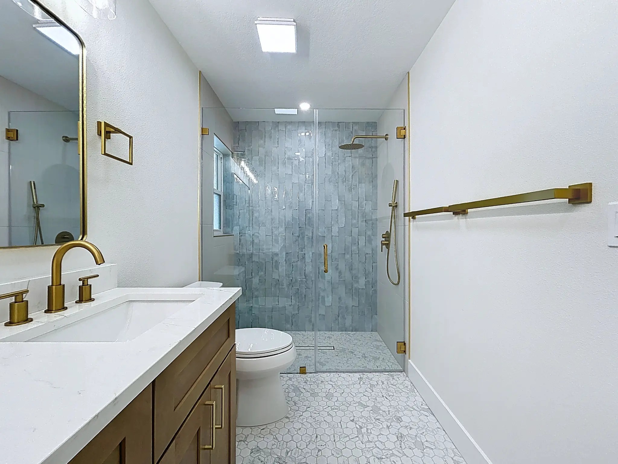 Tampa Bay bathroom remodeling — Belleair Beach blue tile and brass bathroom renovation
