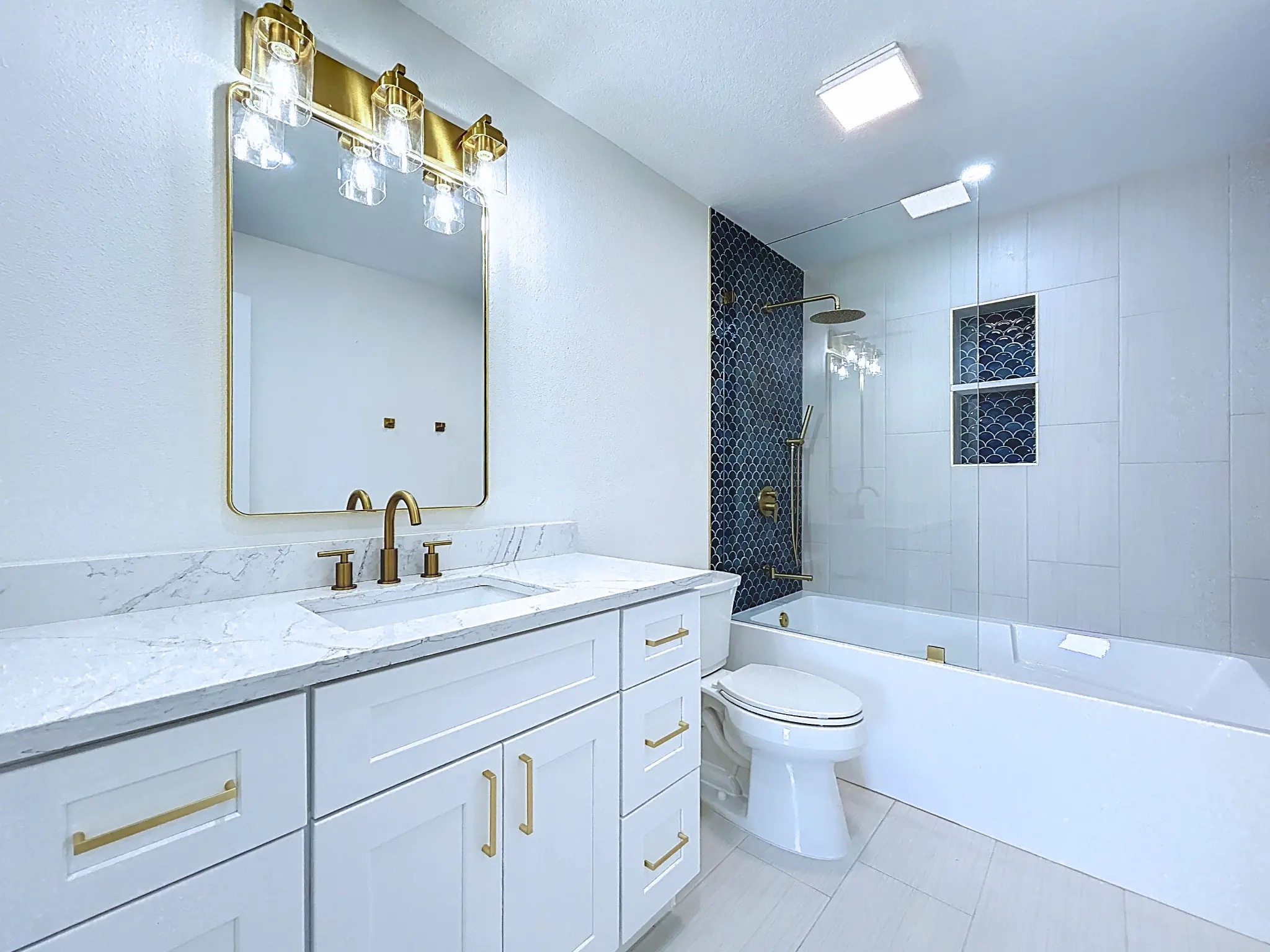 Tampa Bay bathroom remodeling — Belleair Beach blue tile and brass bathroom renovation