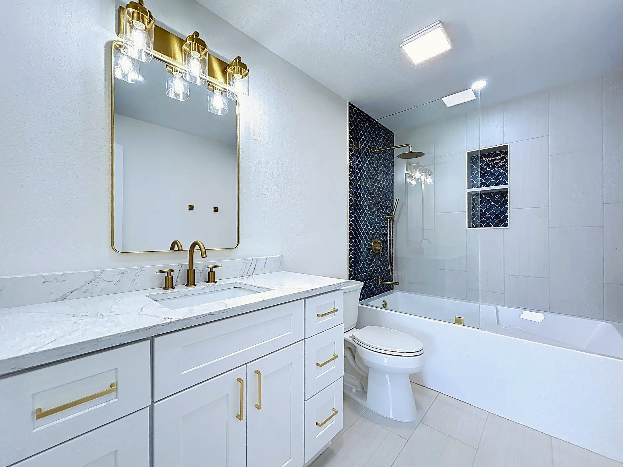 Tampa Bay bathroom remodeling — Belleair white and brass double vanity and tub