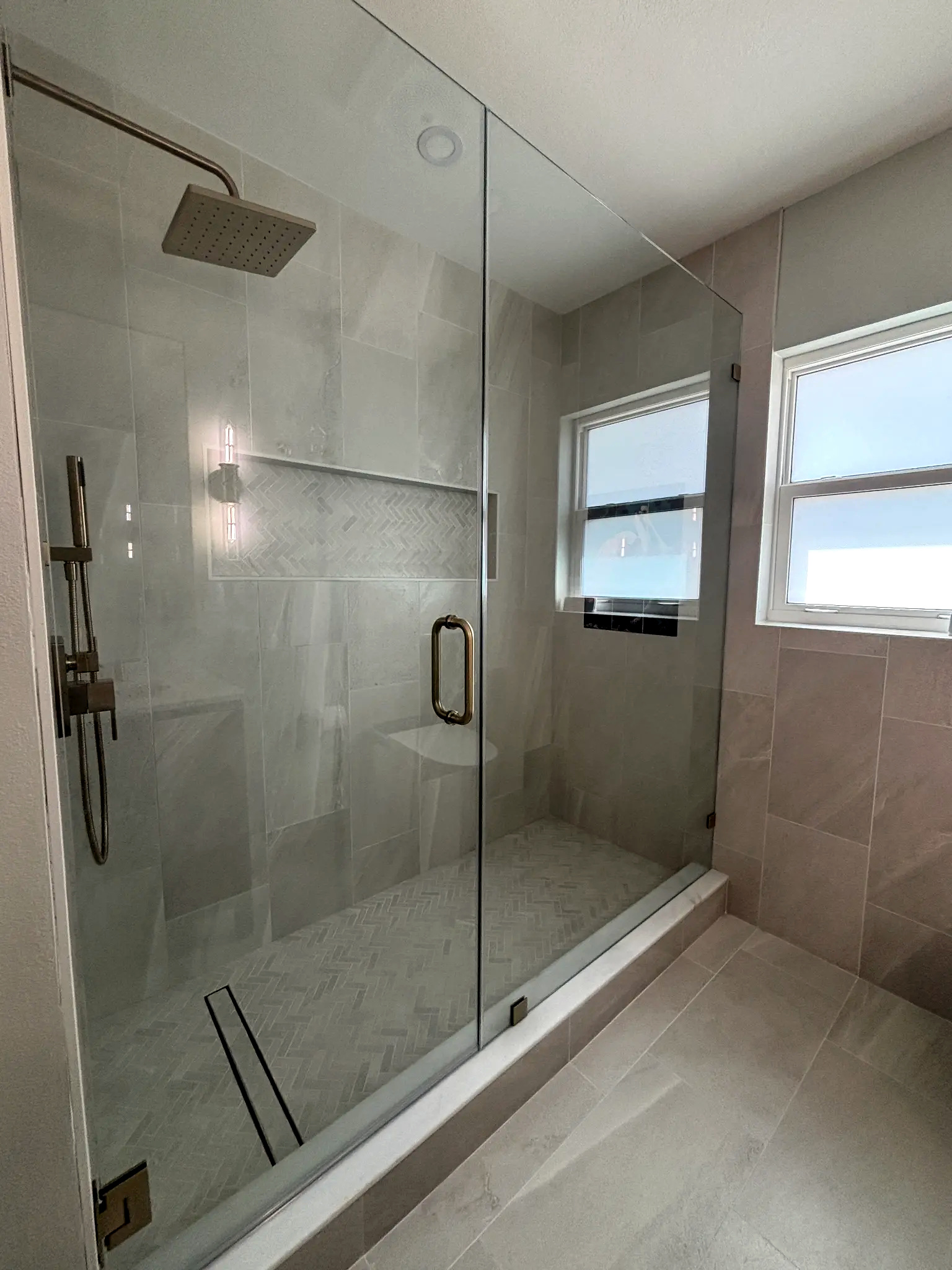 Bathroom remodeling in Tampa Bay — Grey chevron tile shower niche
