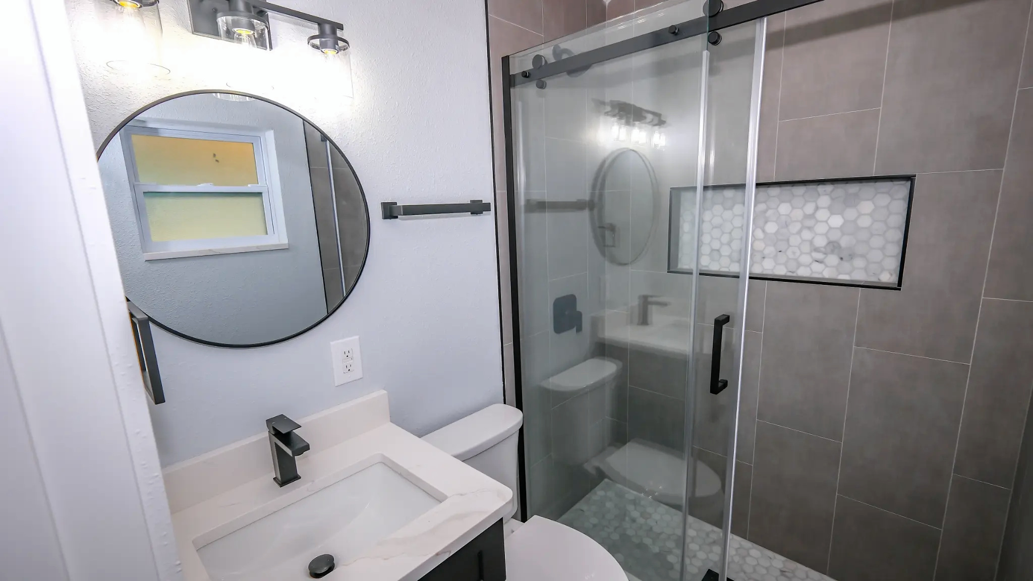 Bathroom remodeling in Tampa Bay — Large-format tile bathroom with black vanity