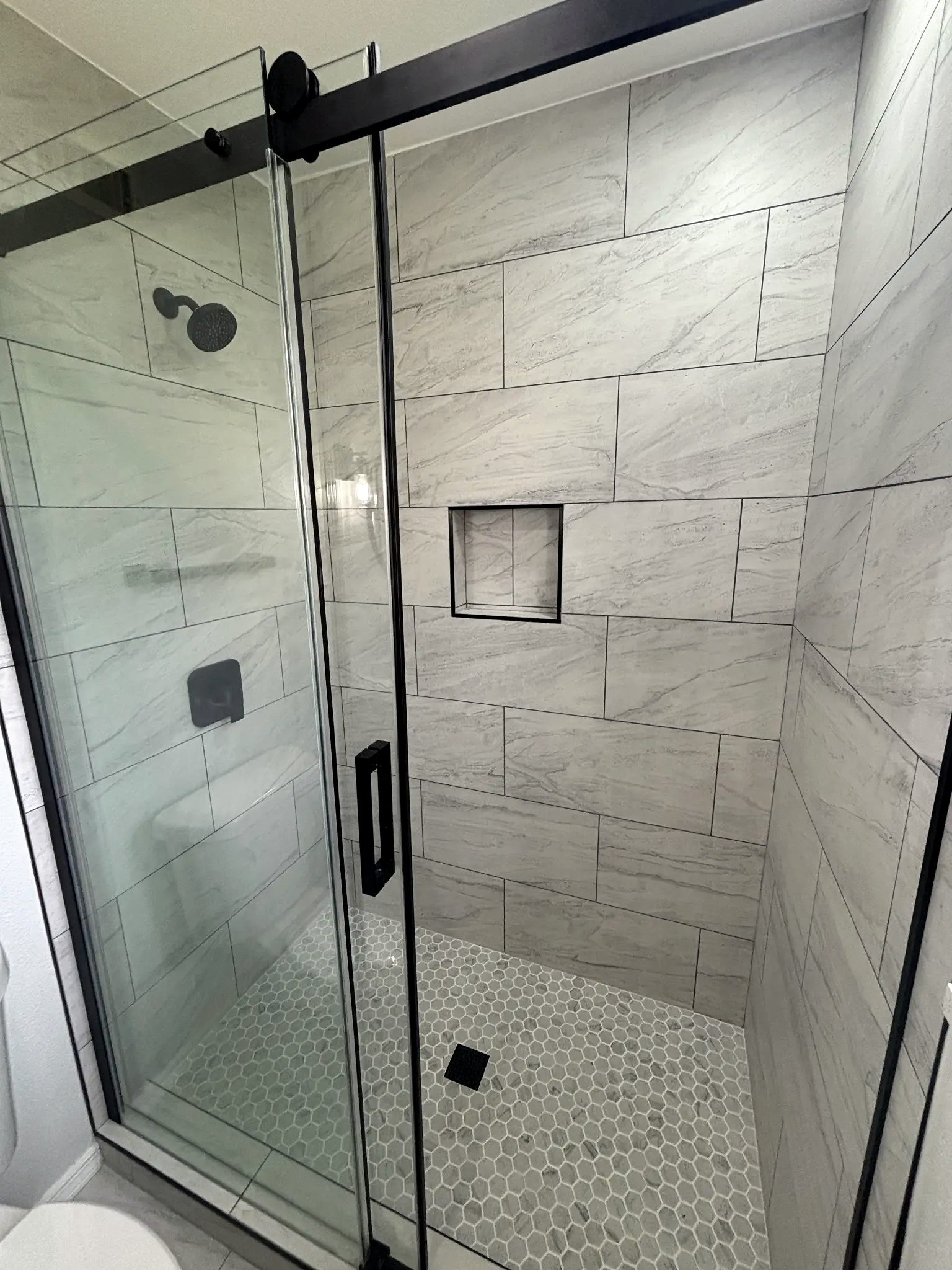 Bathroom remodeling in Tampa Bay — Grey tile shower with black fixtures