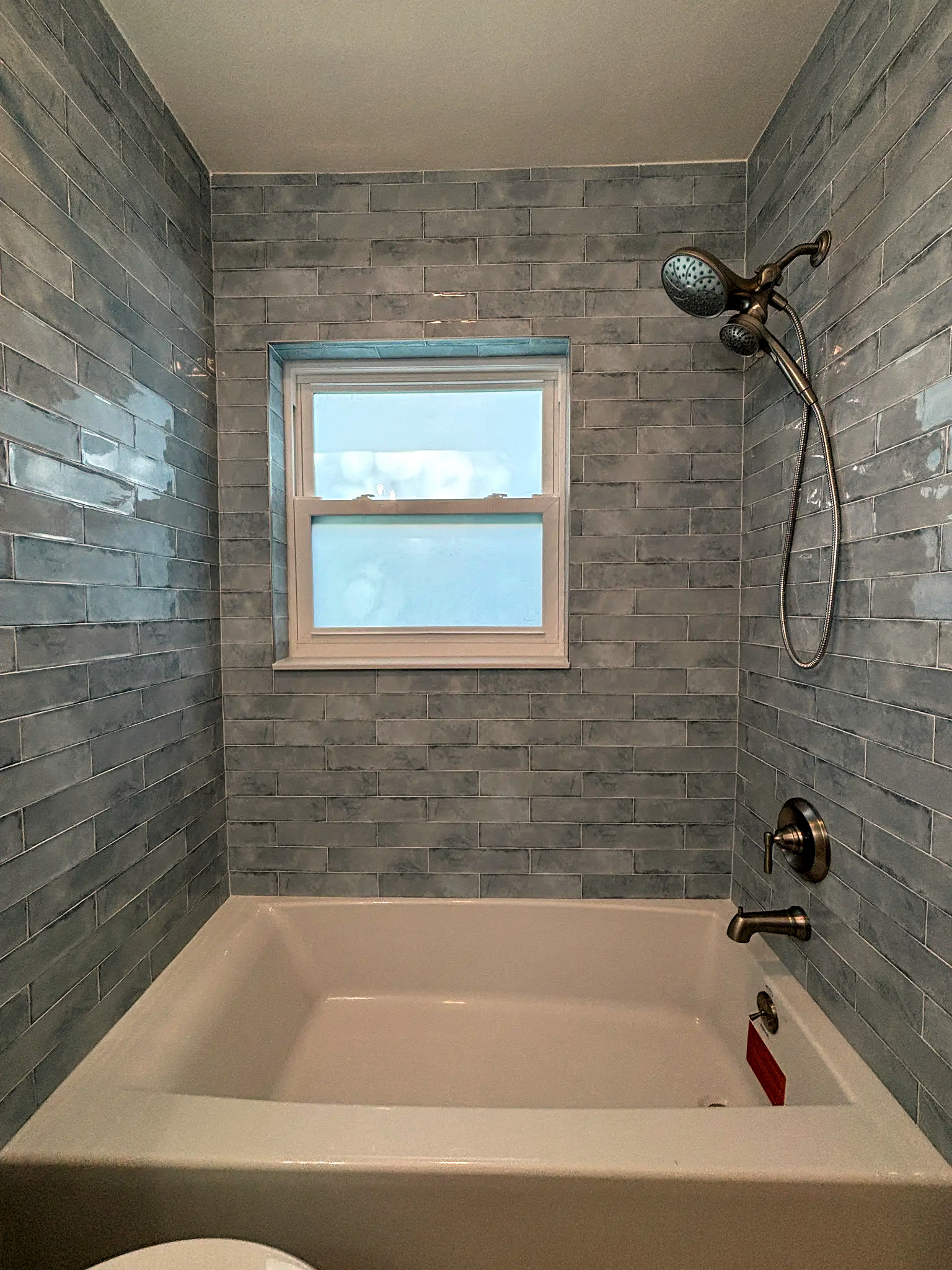 Bathroom remodeling in Tampa Bay — Light blue glass subway tile bathroom tub
