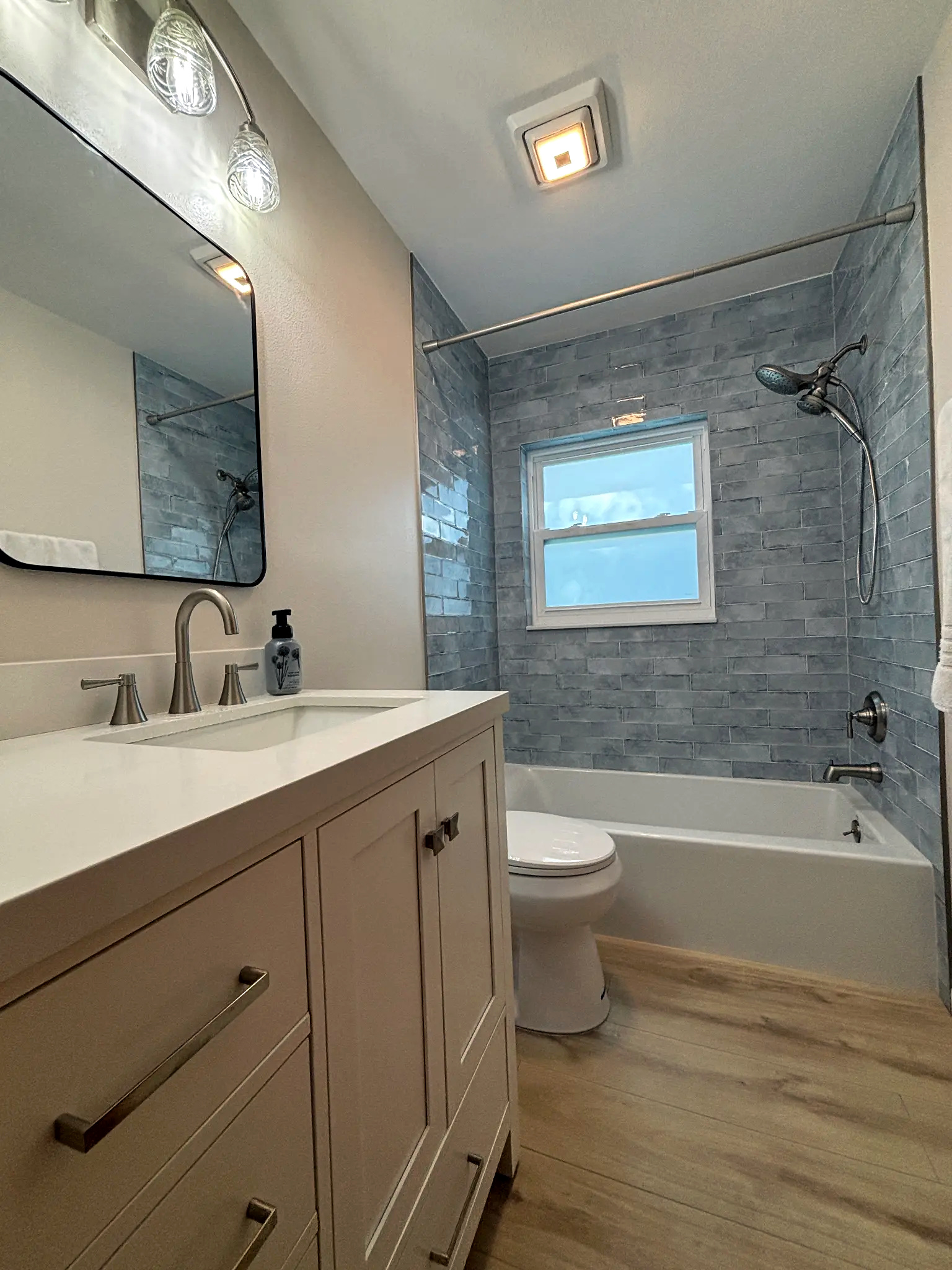 Bathroom remodeling in Tampa Bay — Light blue glass subway tile bathroom vanity