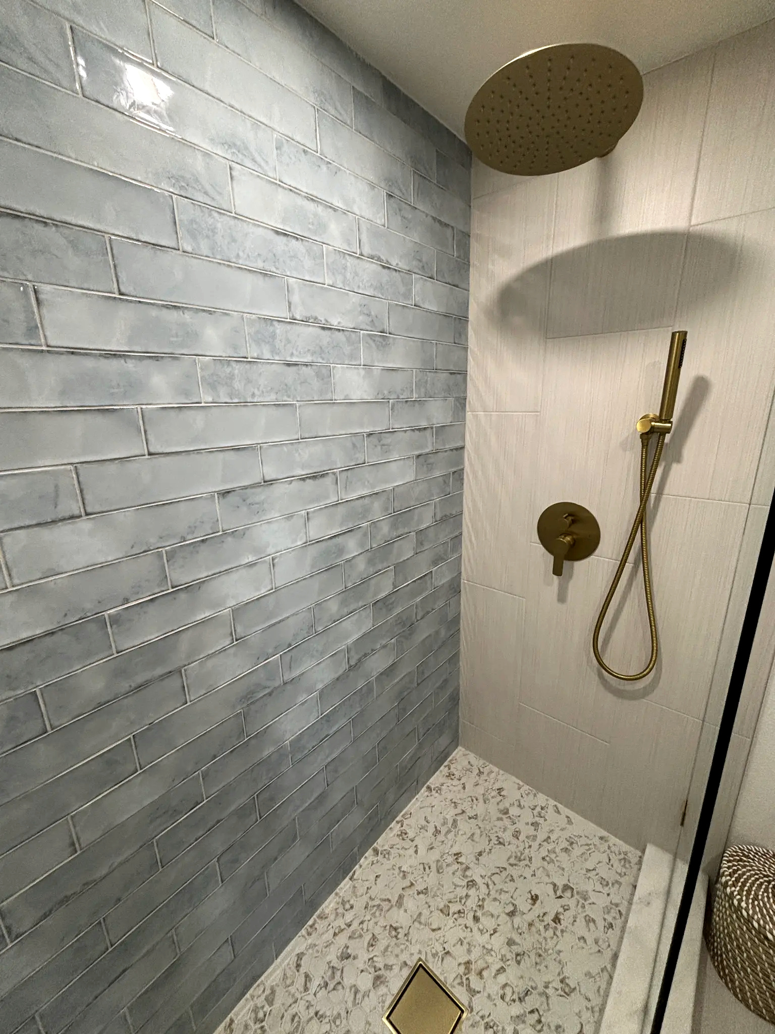 Bathroom remodeling in Tampa Bay — Light blue tile bathroom with gold fixtures