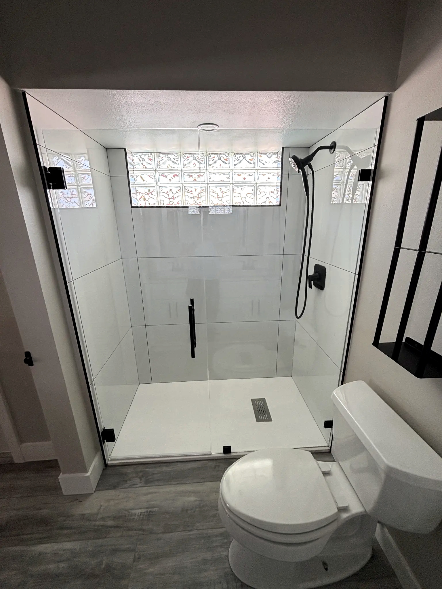 Bathroom remodeling in Tampa Bay — White tile shower with black fixtures