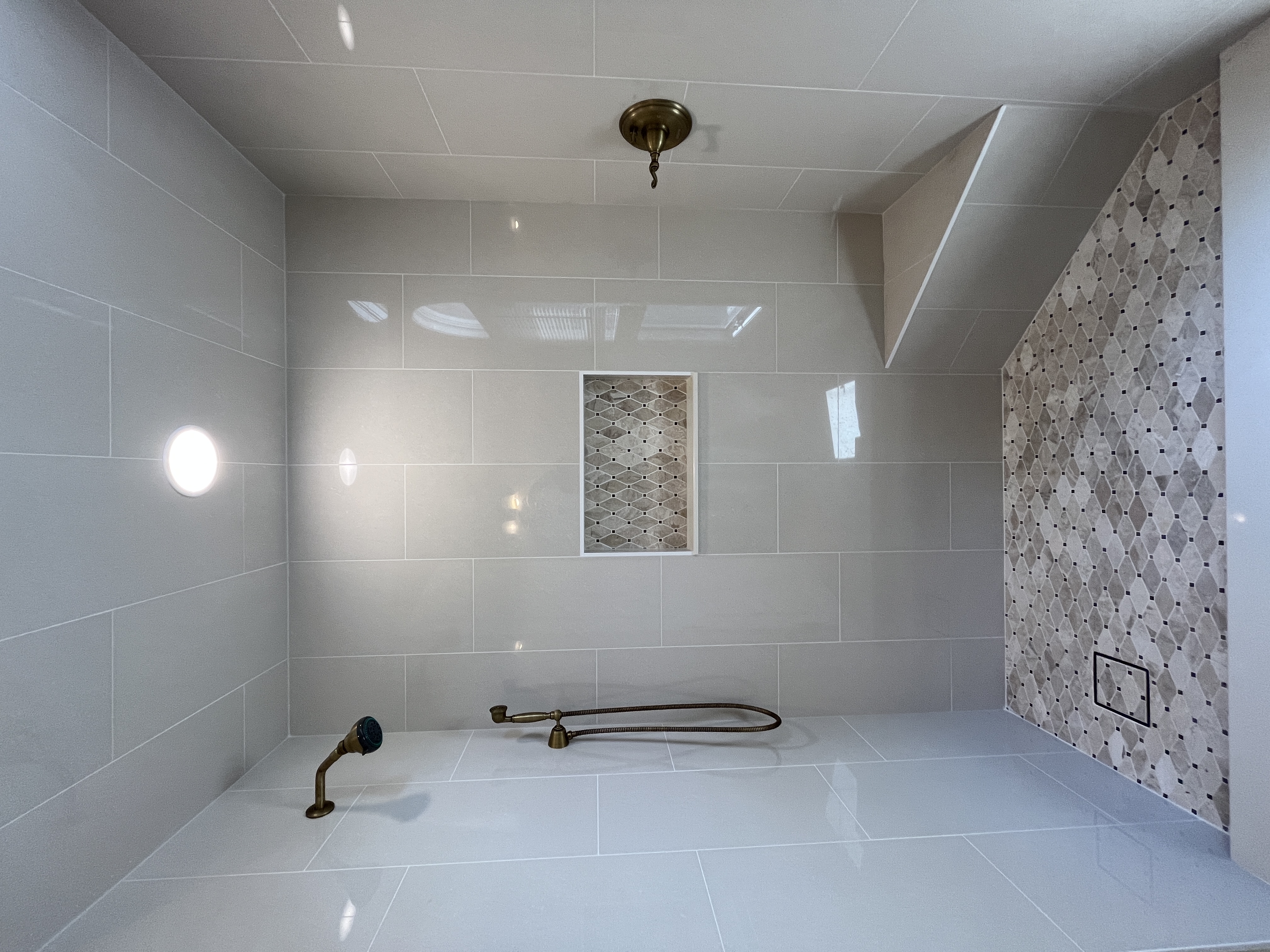 Large format tile shower with brass fixtures — Tampa Bay