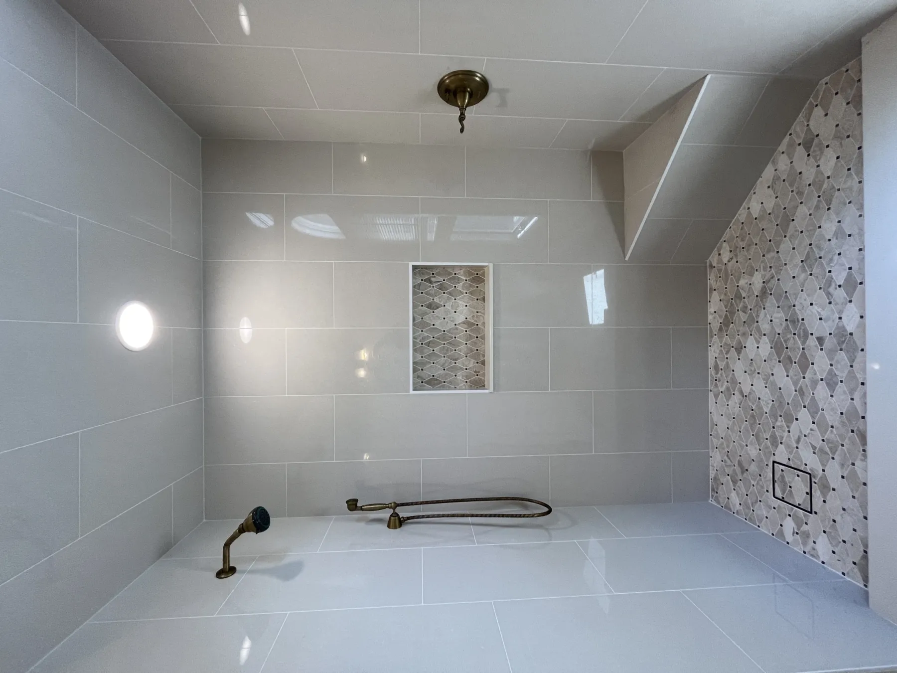 Large format tile shower with brass fixtures — Tampa Bay