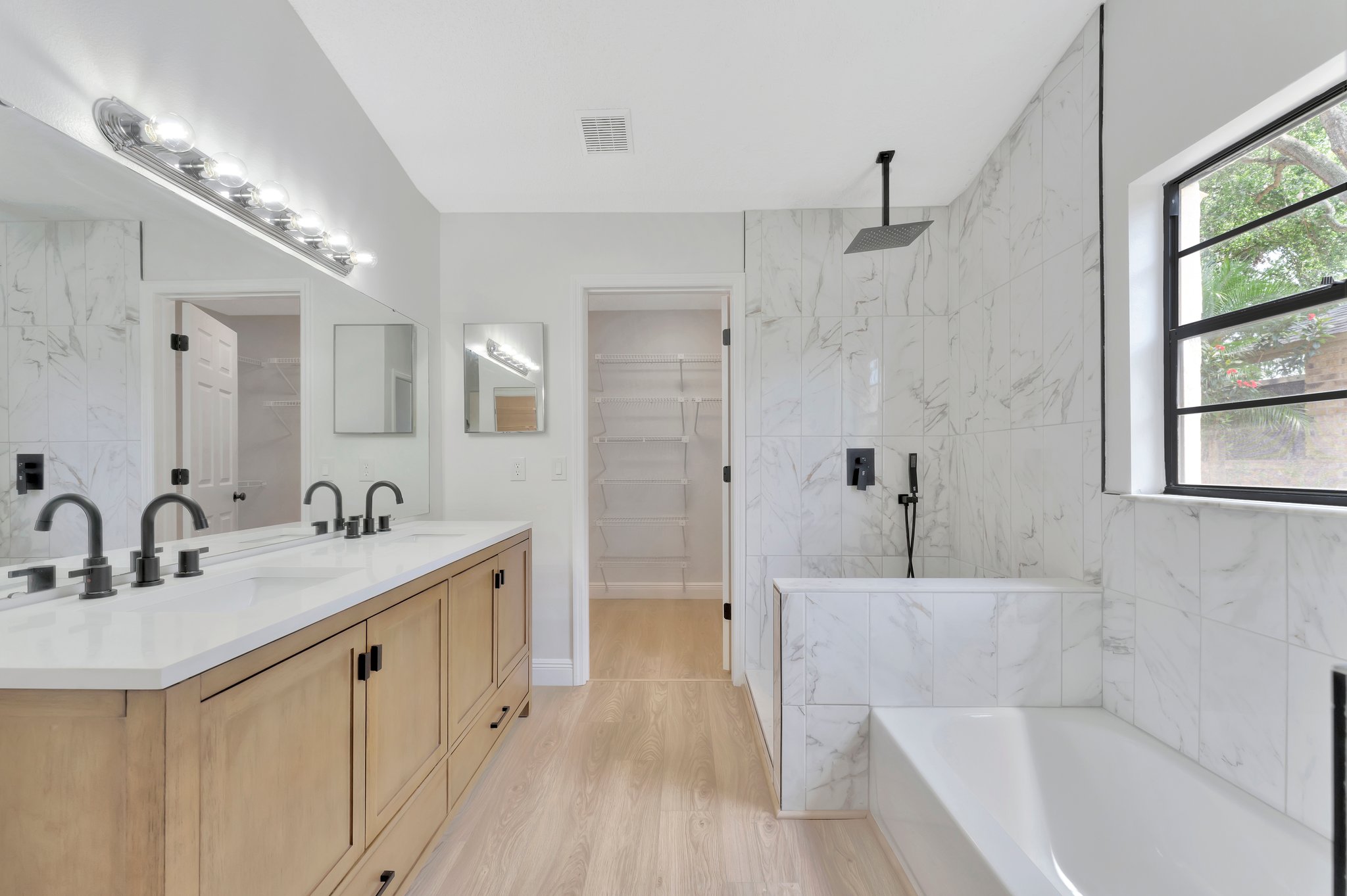 White oak double vanity with marble wet room — Tampa Bay