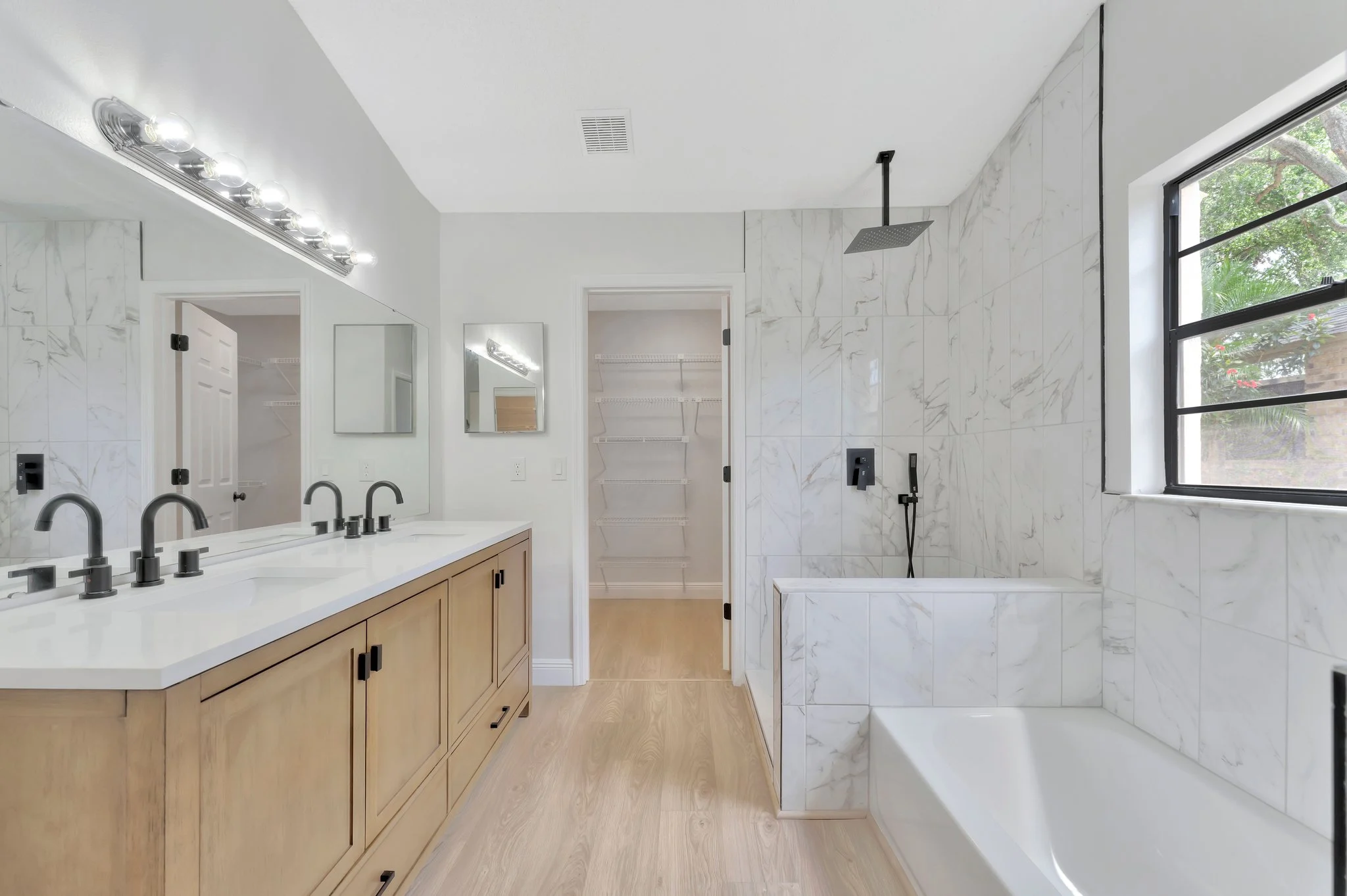 White oak double vanity with marble wet room — Tampa Bay