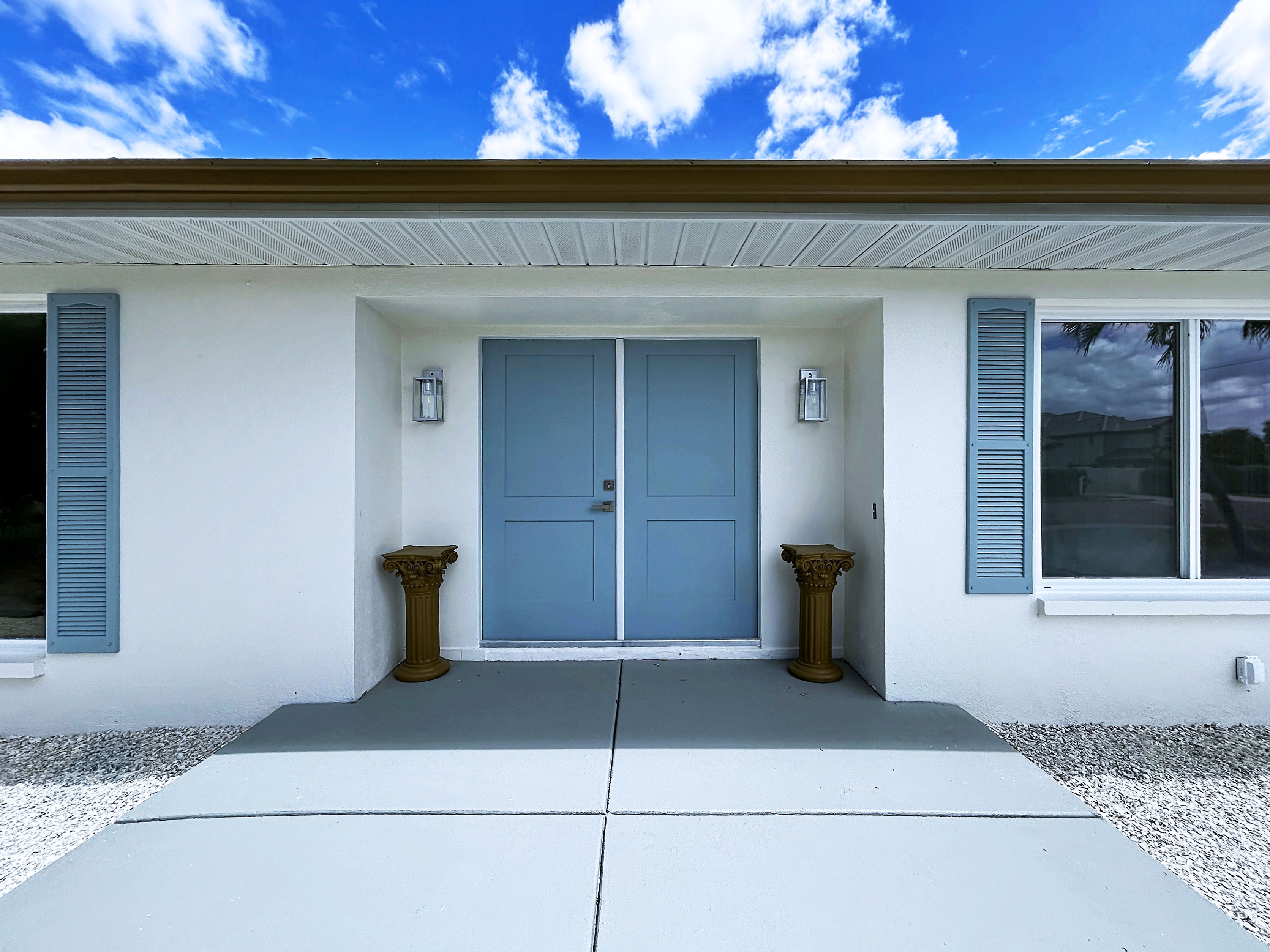 Belleair Beach front entry with blue doors and shutters &mdash; Tampa Bay exterior painting