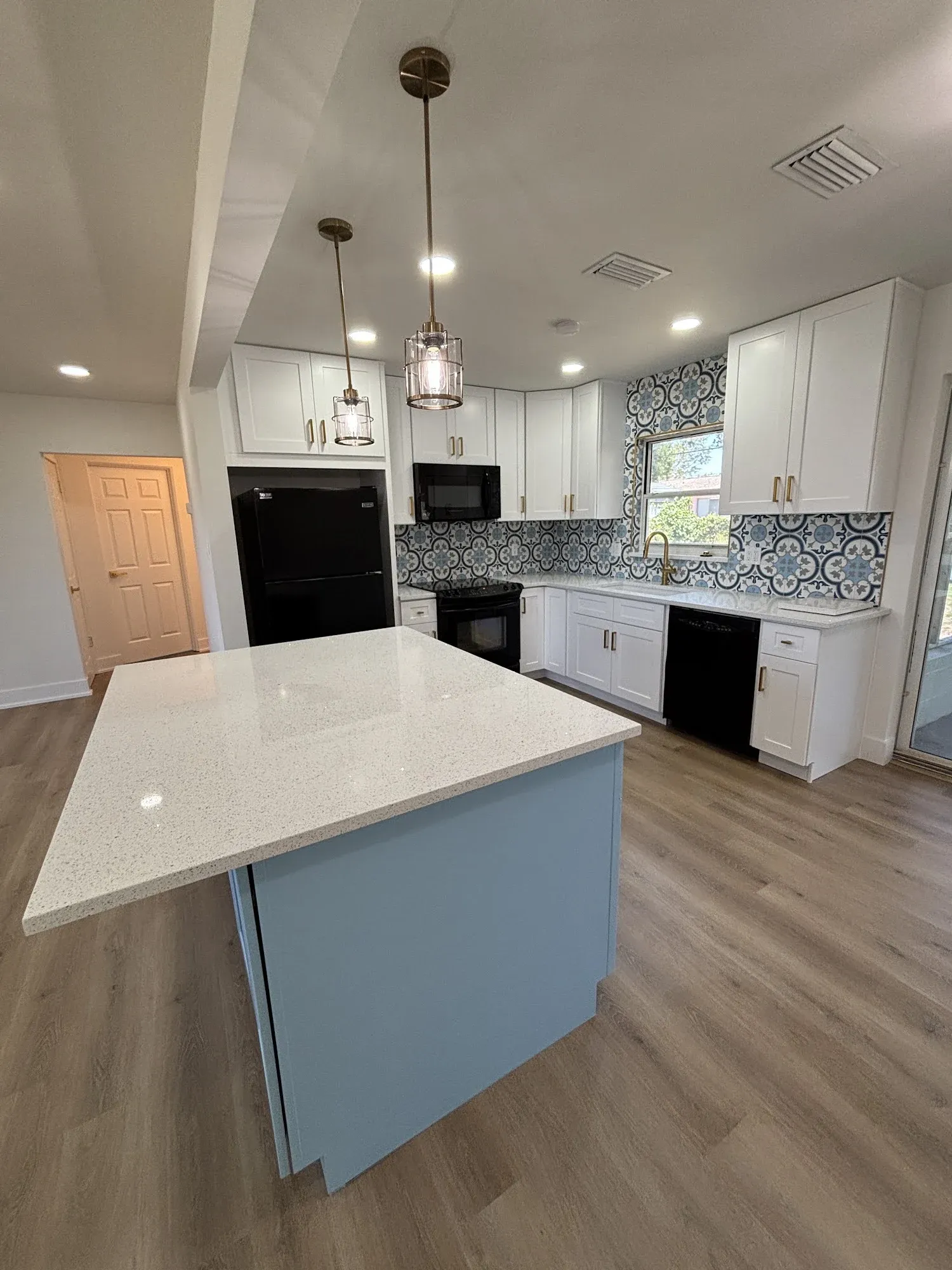 St. Petersburg kitchen after the remodel, opened up with a blue island