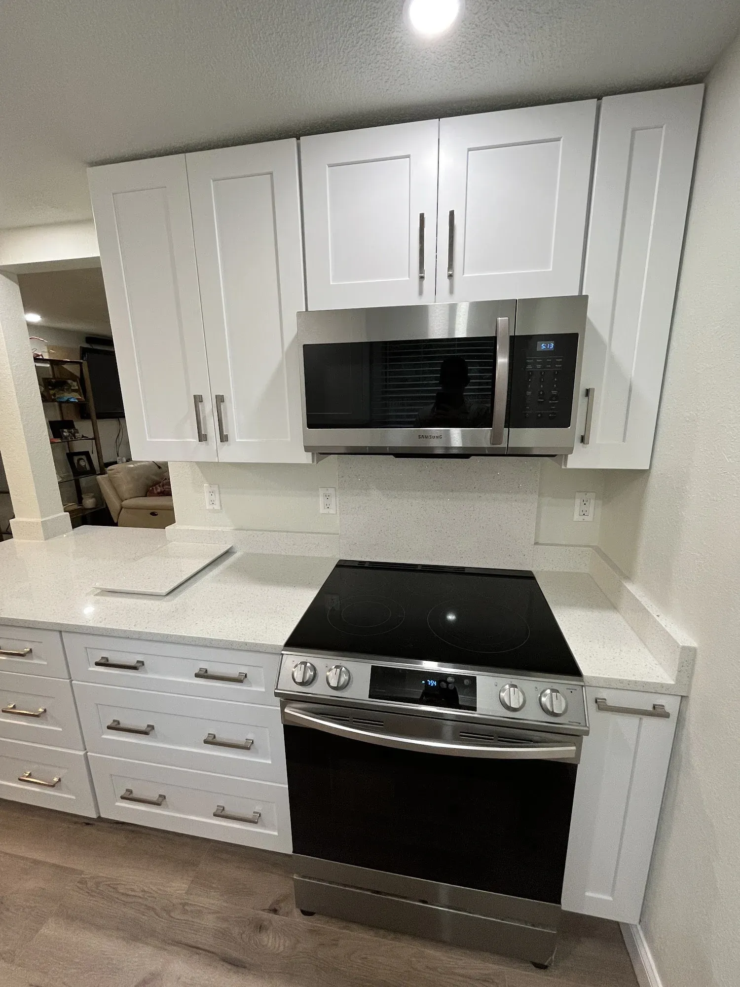 Remodeled white shaker galley kitchen with quartz countertops, Tampa Bay