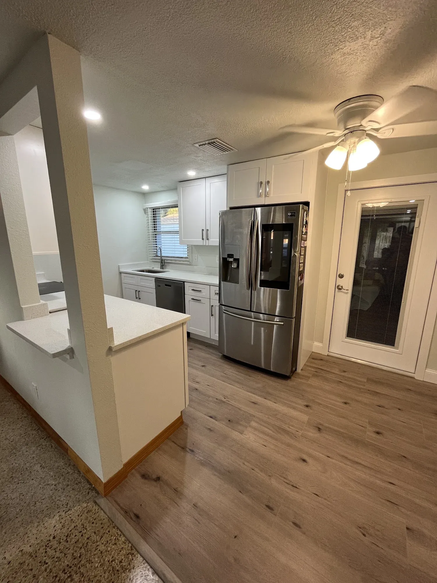 Remodeled kitchen pass-through with white shaker cabinets, Tampa Bay
